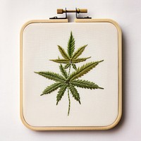 A marijuana in embroidery style pattern plant herbs.