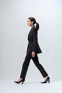 A business woman walking footwear blazer.