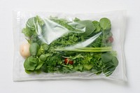 Plastic wrapping over a vegetable plant herbs food.