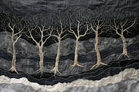 Embroidery with dry trees on dark sky textile plant art.