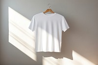 White t-shirt hanging on Clothes rack  sleeve coathanger clothing.