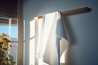 White towel hanging on Towel stand room bathroom light.