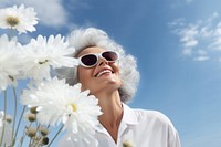 Happy Mature woman wearing white outfit flower sunglasses portrait.