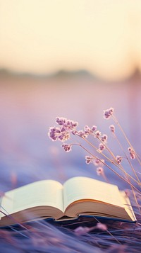  A open book on purple meadow publication outdoors flower. AI generated Image by rawpixel.