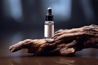 A Moisturizing serum floating on top of a drift wood cosmetics perfume bottle. AI generated Image by rawpixel.