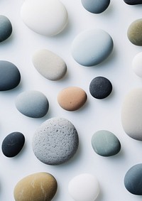  Flat lay rocks sitting on top of a white surface backgrounds pebble pill. AI generated Image by rawpixel.