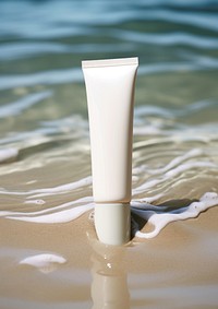  A tube of cream sitting in a stream of water sea reflection cosmetics. 