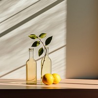 A glass bottle with two lemons sitting on a table refreshment container freshness. AI generated Image by rawpixel.