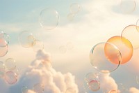 A group of soap bubbles floating in the cloud sky backgrounds outdoors nature.
