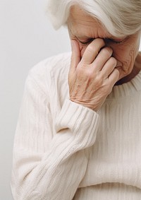 A elderly woman hand on face worried adult white.