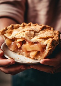 A person holding piece of apple pie dessert food breakfast.