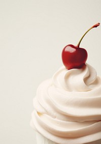 A whipped cream and a cherry on top dessert cupcake fruit.