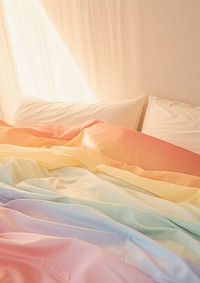 Rainbow lighting on bed furniture blanket pillow.