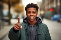 A happy african american teenager man with confident portrait jacket finger.