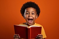African kid happy face reading a book publication child intelligence.