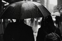 People in the city rain monochrome umbrella.