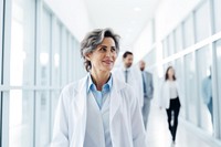 Mature female doctors corridor hospital walking. AI generated Image by rawpixel.