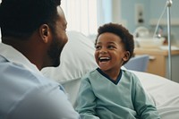 African american patient boy hospital laughing doctor. 