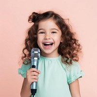 Girl holding microphone portrait child happy. AI generated Image by rawpixel.
