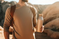 Man holding water bottle photo refreshment tranquility. AI generated Image by rawpixel.