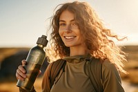 Woman holding water bottle portrait smile photo. 