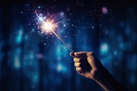 Magic wand glowing holding star.