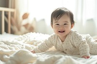 Asian baby girl smiling cozy bed.