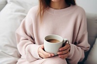 Woman holding a cup of tea sweater coffee drink. AI generated Image by rawpixel.