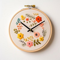 Cute clock in embroidery needlework textile pattern.