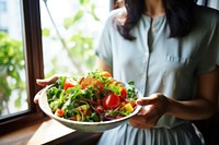 Woman eating healthy salad restaurant adult food. AI generated Image by rawpixel.