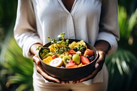 Black woman bowl outdoors fruit.