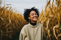 Black mixed woman smiling harvest sweater.