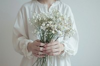 Person holding flowers plant midsection freshness.