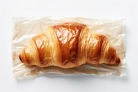 Plastic wrapping over a croissant bread food white background.