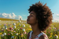 Photo of black woman in flower field summer adult contemplation.