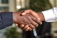 Photo of shaking hands handshake agreement greeting.