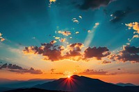 Photo of sunset behind a mountain sunlight sky outdoors.