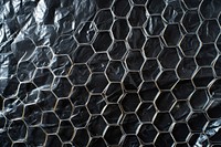 Plastic wrap with honeycomb patterns backgrounds texture black.