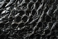 Plastic wrap with honeycomb patterns backgrounds black repetition.