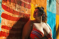 Chubby Latina woman in a swimming costume standing in front of a colorful wall swimwear portrait fashion. AI generated Image by rawpixel.