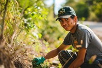A young Latino environmentalist leading a community cleanup campaign outdoors gardening nature. AI generated Image by rawpixel.
