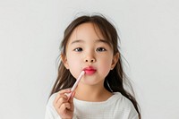 Little south east asian girl toothbrush cosmetics portrait.