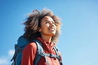 African young woman hiking backpack looking blue.