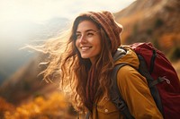 Woman hiking mountain backpack smiling.
