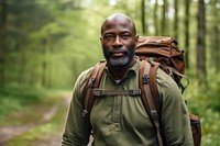 African middle age man With Backpack backpack portrait forest.