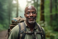 African middle age man With Backpack portrait backpack forest.