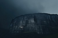 Dark background cliff sky mountain.