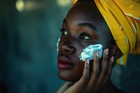 Black South African woman skin portrait applying.