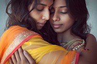 Portrait of two indian women hugging jewelry photo.