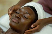 Ghanan woman spa relaxation forehead.